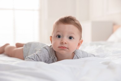 Photo of Cute little baby on bed at home