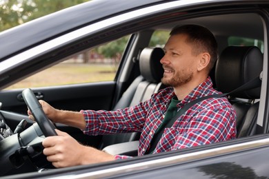 Photo of Man driving modern car, view through window