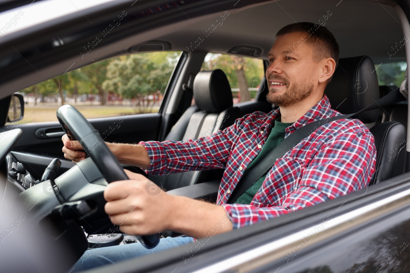 Photo of Man driving modern car, view through window