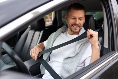 Photo of Man driving modern car, view through window