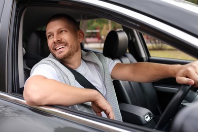 Photo of Man driving modern car, view through window