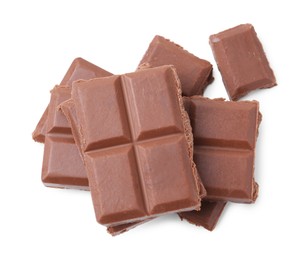 Photo of Pieces of delicious milk chocolate isolated on white, top view