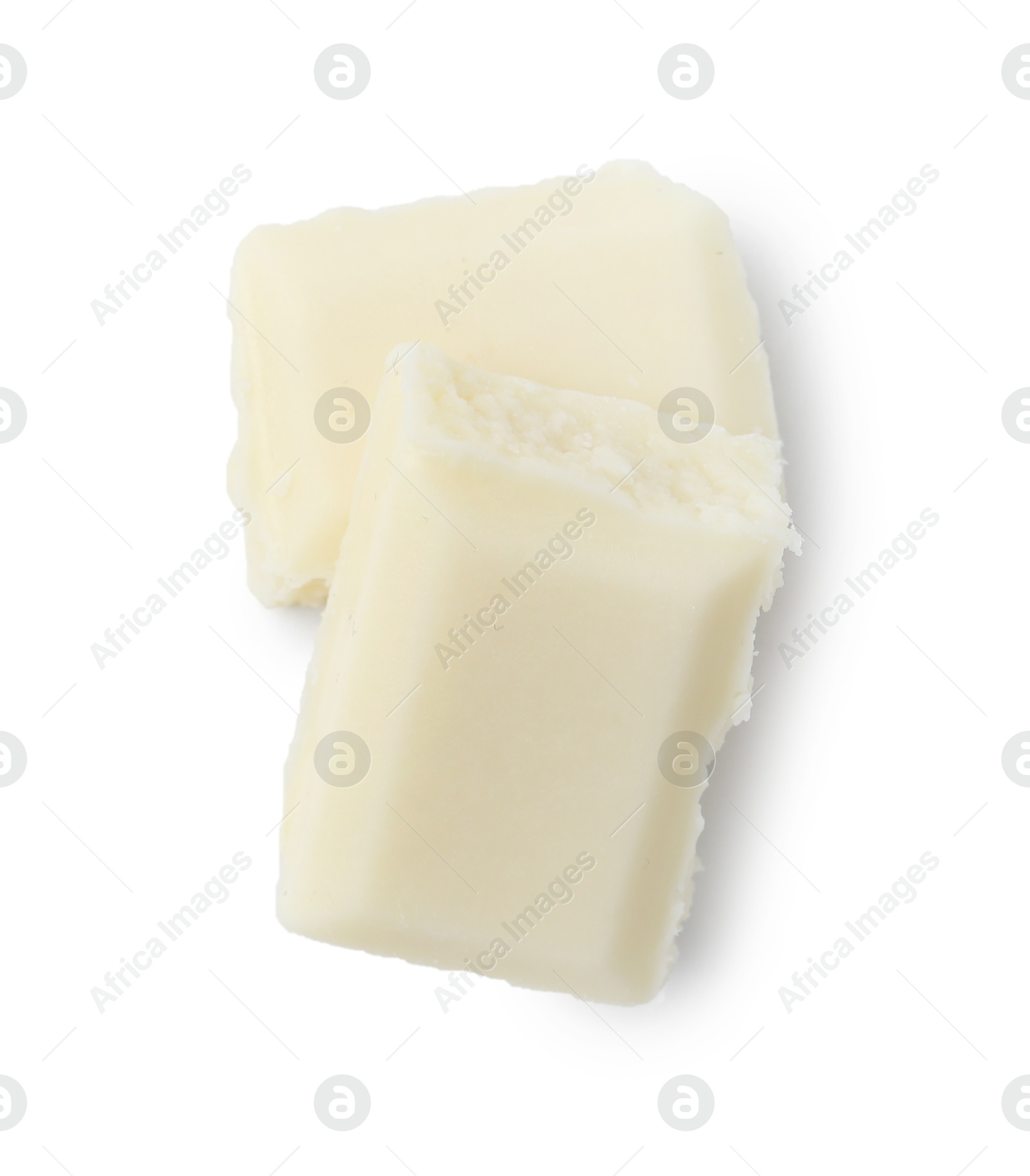 Photo of Pieces of delicious white chocolate isolated on white, top view