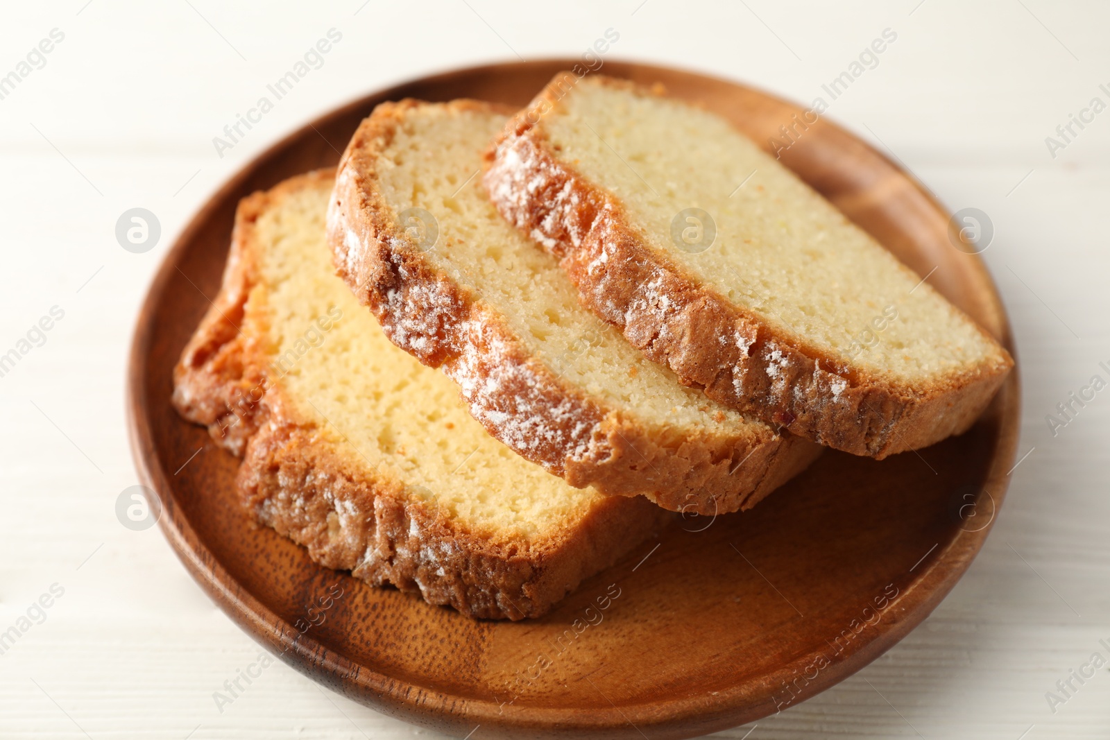 Photo of Freshly baked sponge cake on white wooden table, closeup