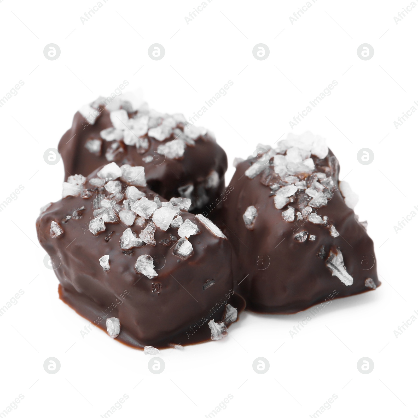 Photo of Tasty chocolate candies with salt isolated on white