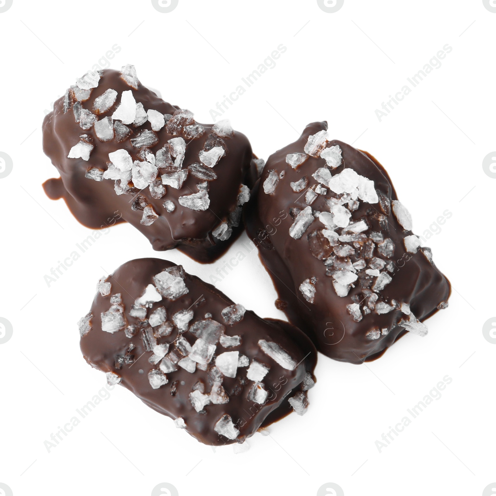 Photo of Tasty chocolate candies with salt isolated on white, top view