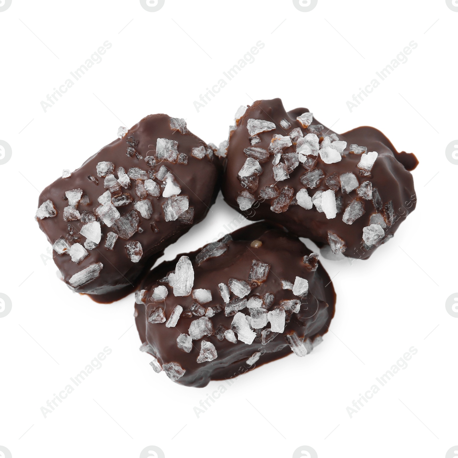 Photo of Tasty chocolate candies with salt isolated on white, top view