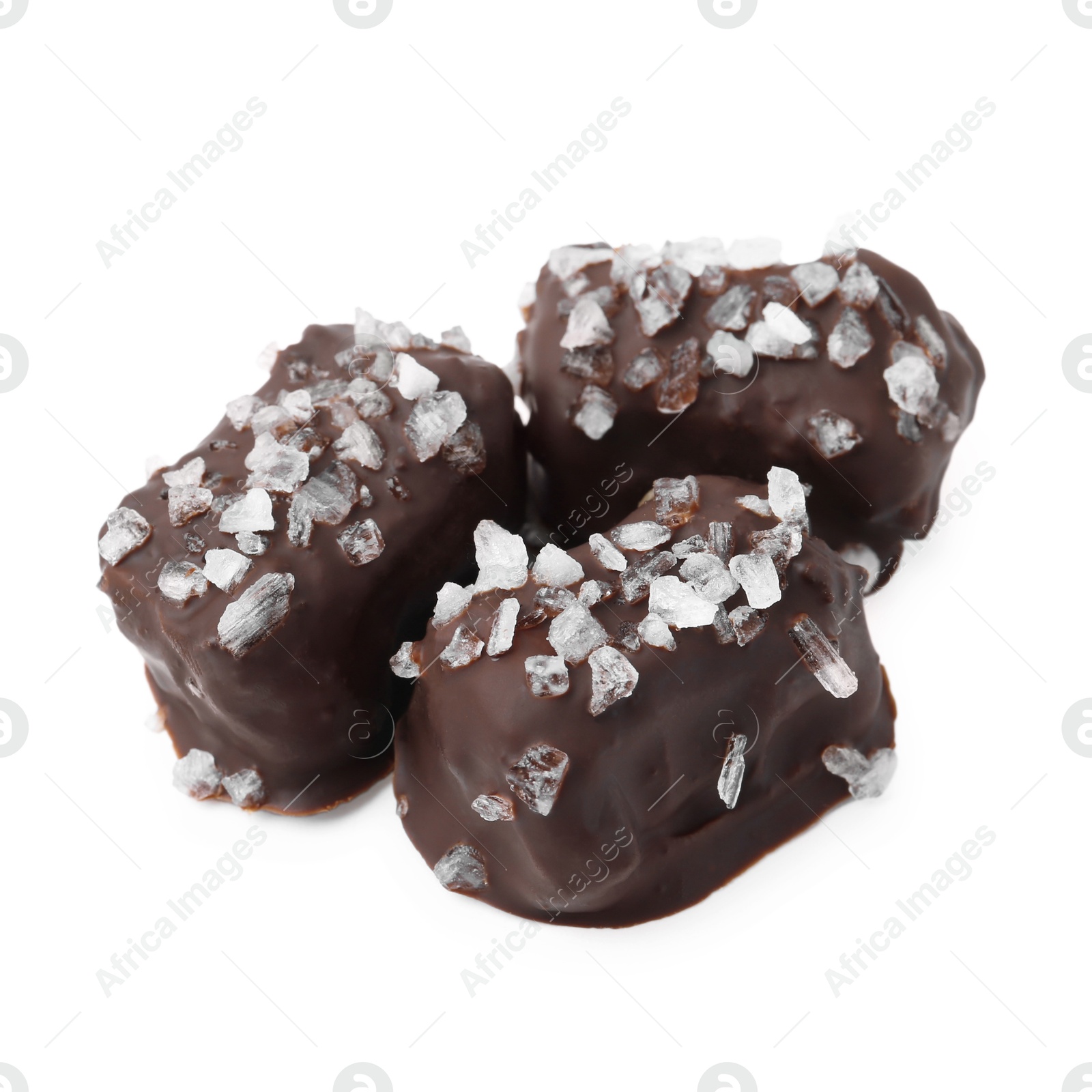 Photo of Tasty chocolate candies with salt isolated on white