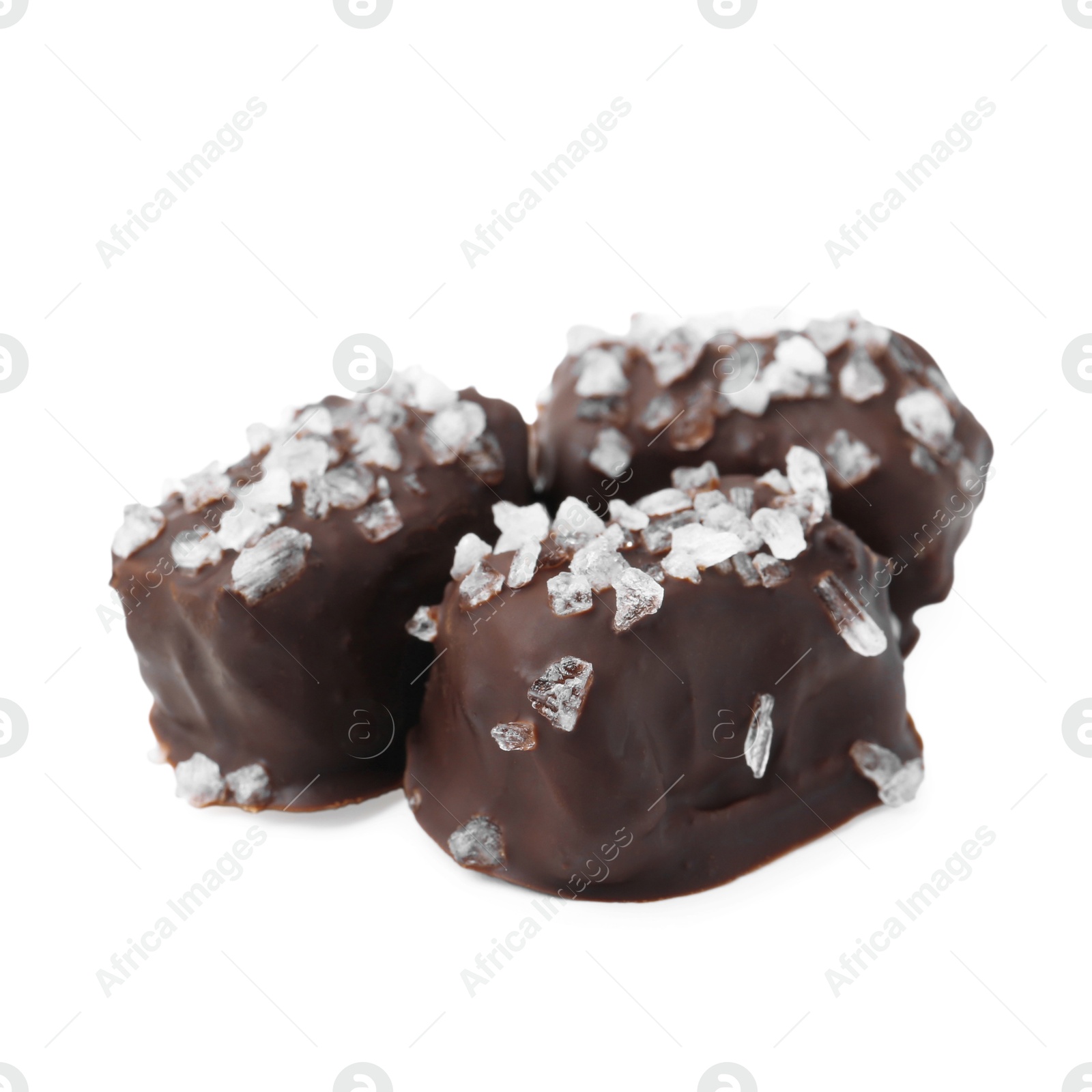 Photo of Tasty chocolate candies with salt isolated on white