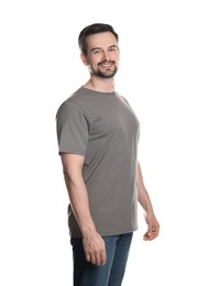 Photo of Man in blank grey t-shirt on white background. Mockup for design