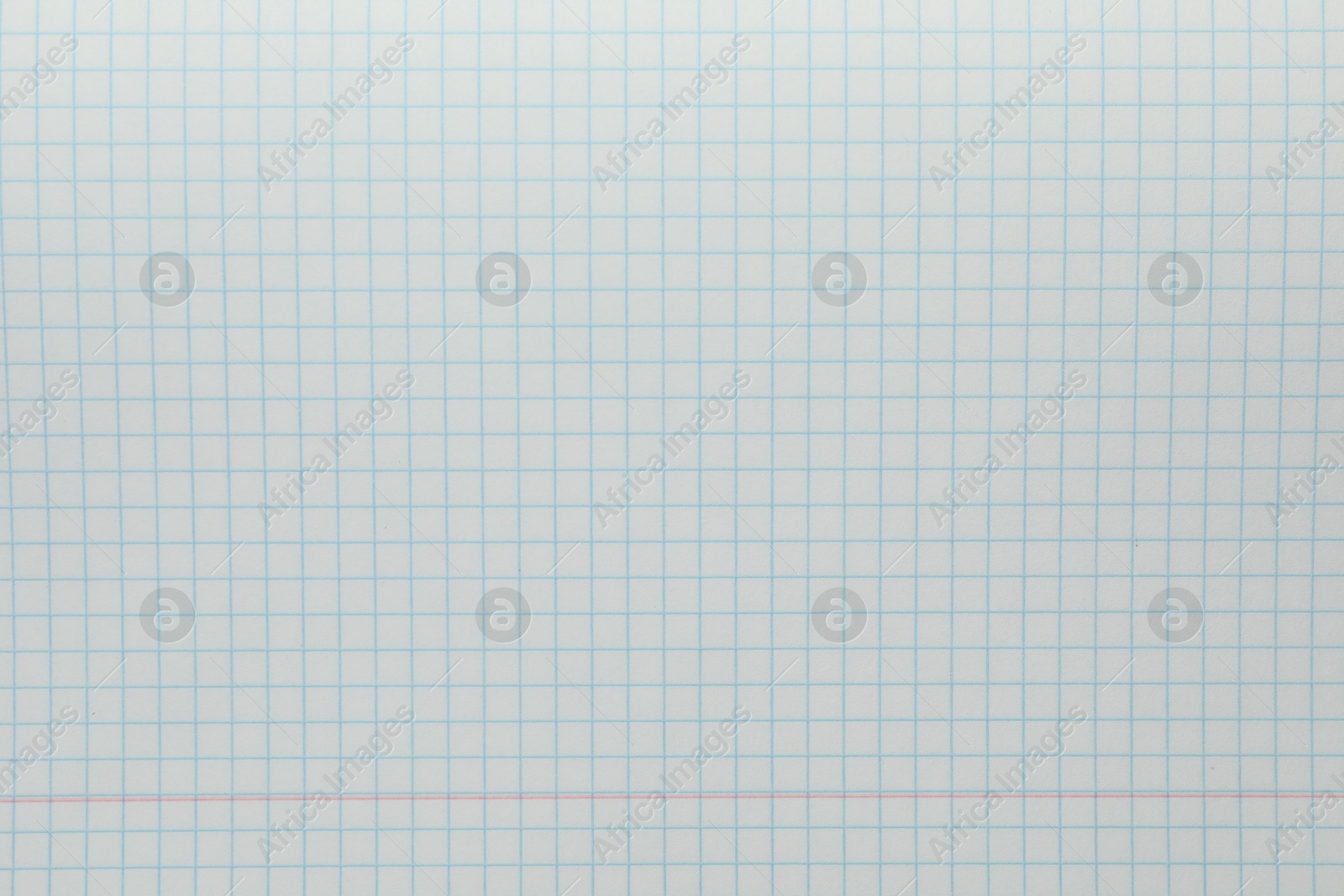 Photo of Checkered copybook sheet as background, top view. School stationery