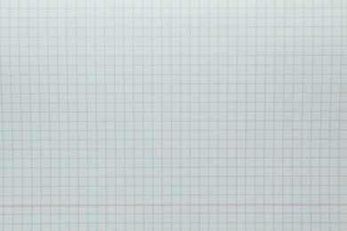 Photo of Checkered copybook sheet as background, top view. School stationery