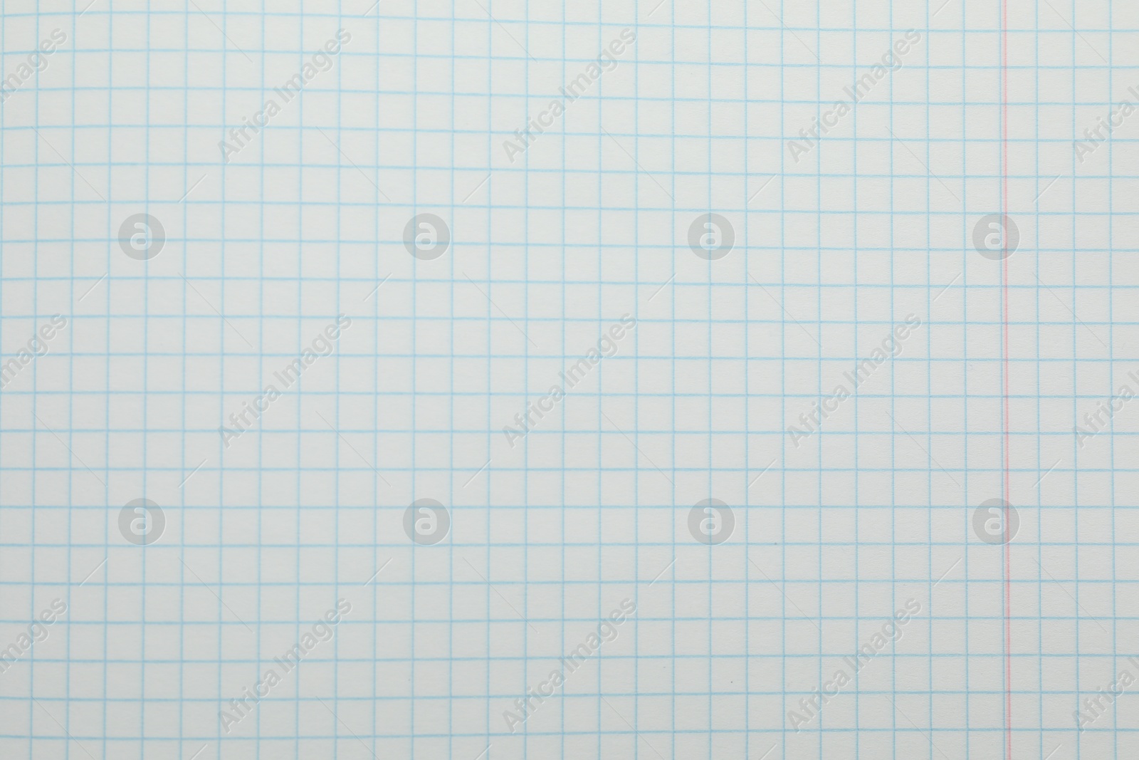 Photo of Checkered copybook sheet as background, top view. School stationery