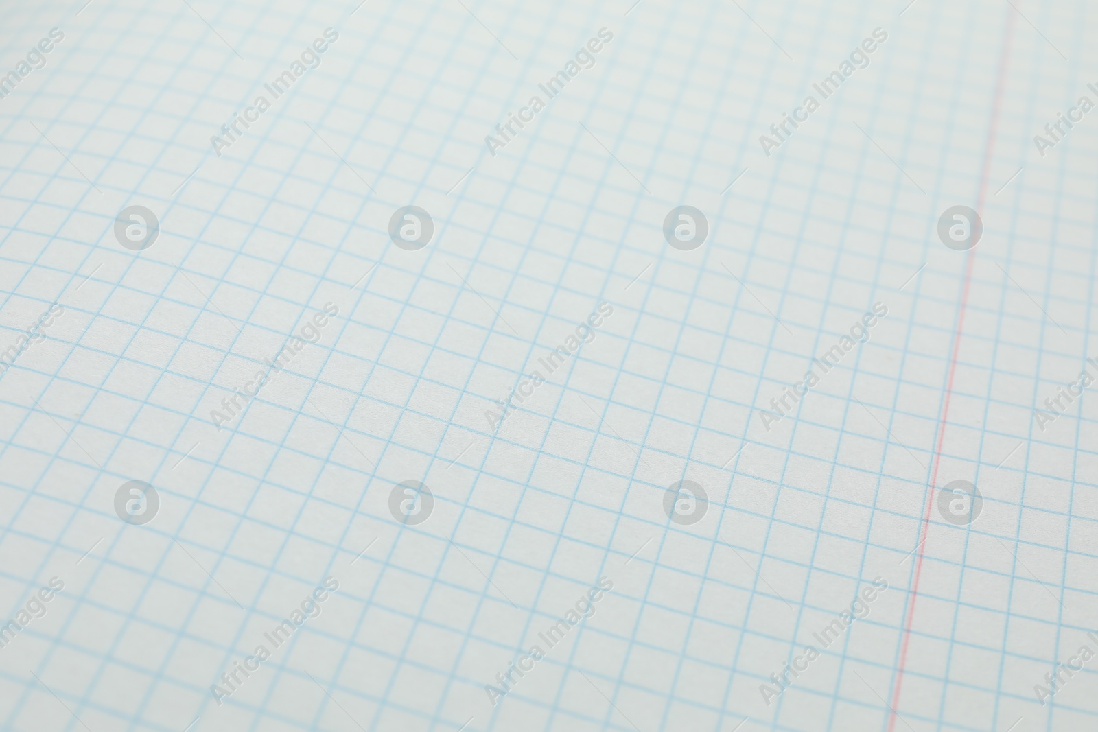 Photo of Checkered copybook sheet as background, closeup. School stationery