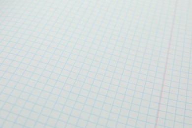 Photo of Checkered copybook sheet as background, closeup. School stationery