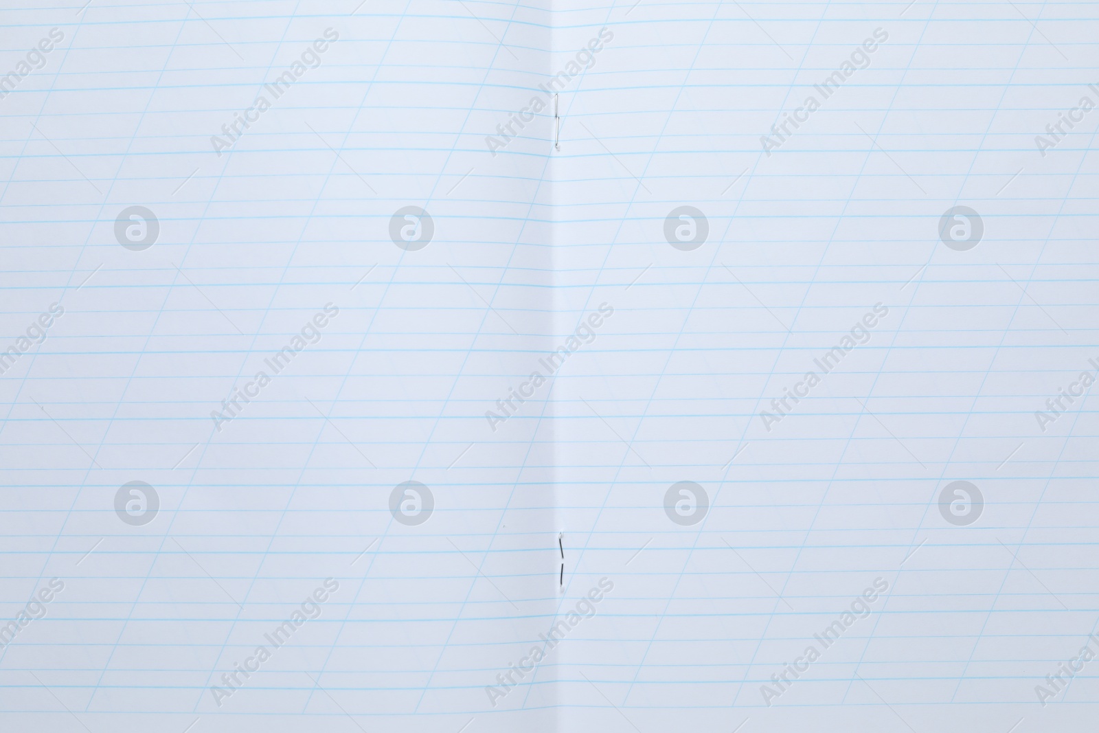 Photo of Open copybook as background, top view. School stationery