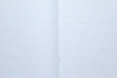 Photo of Open copybook as background, top view. School stationery