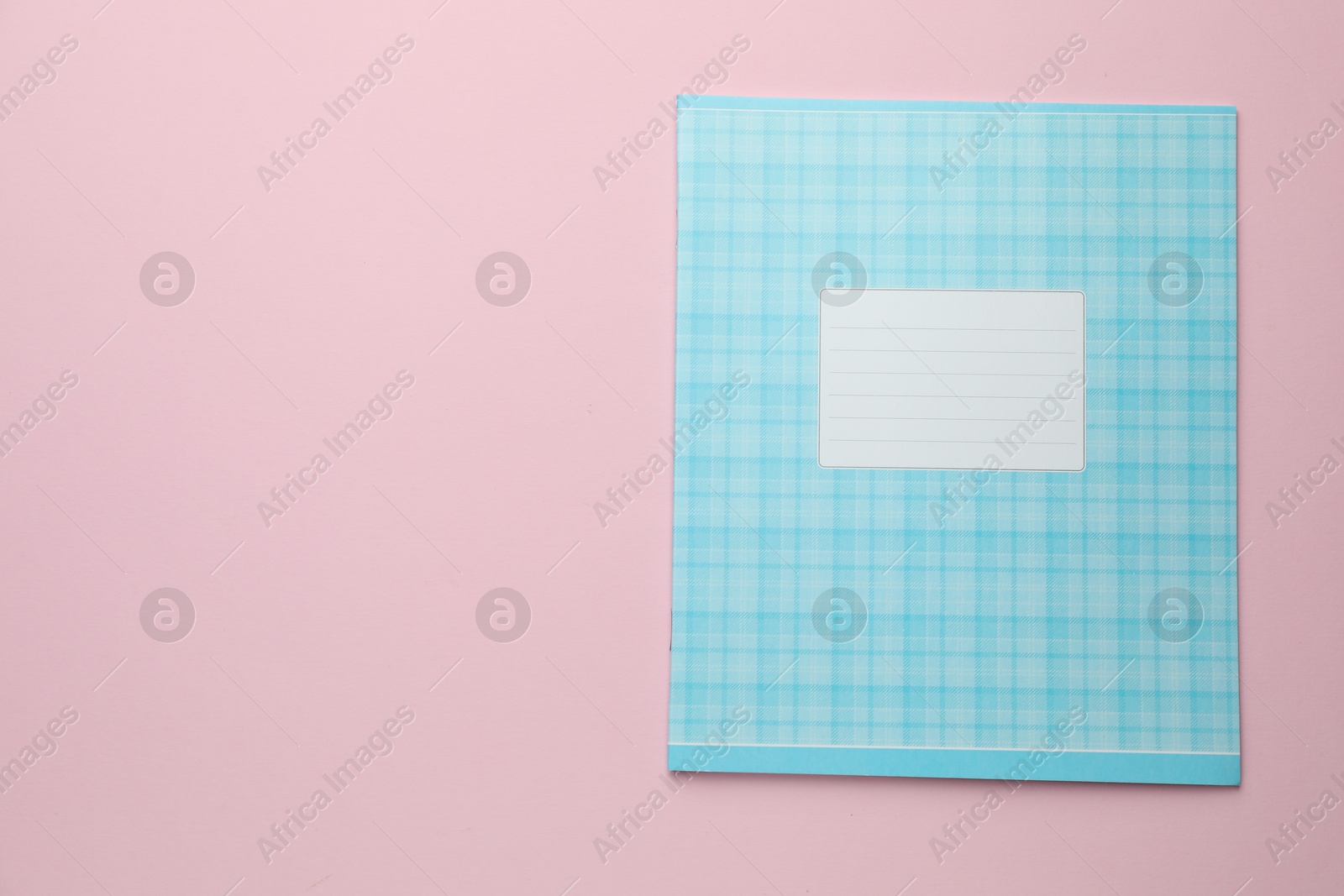 Photo of One copybook on light blue background, top view. Schedule stationary