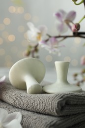 Photo of Spa stones, orchid flowers and towels on table, closeup