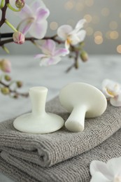 Spa stones, orchid flowers and towels on table, closeup