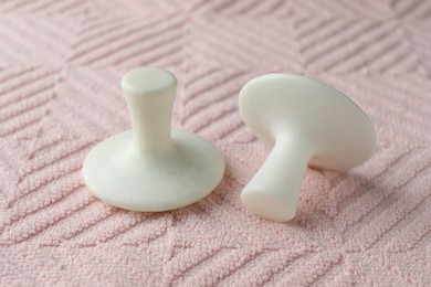 Photo of Two spa stones on pink towel, closeup