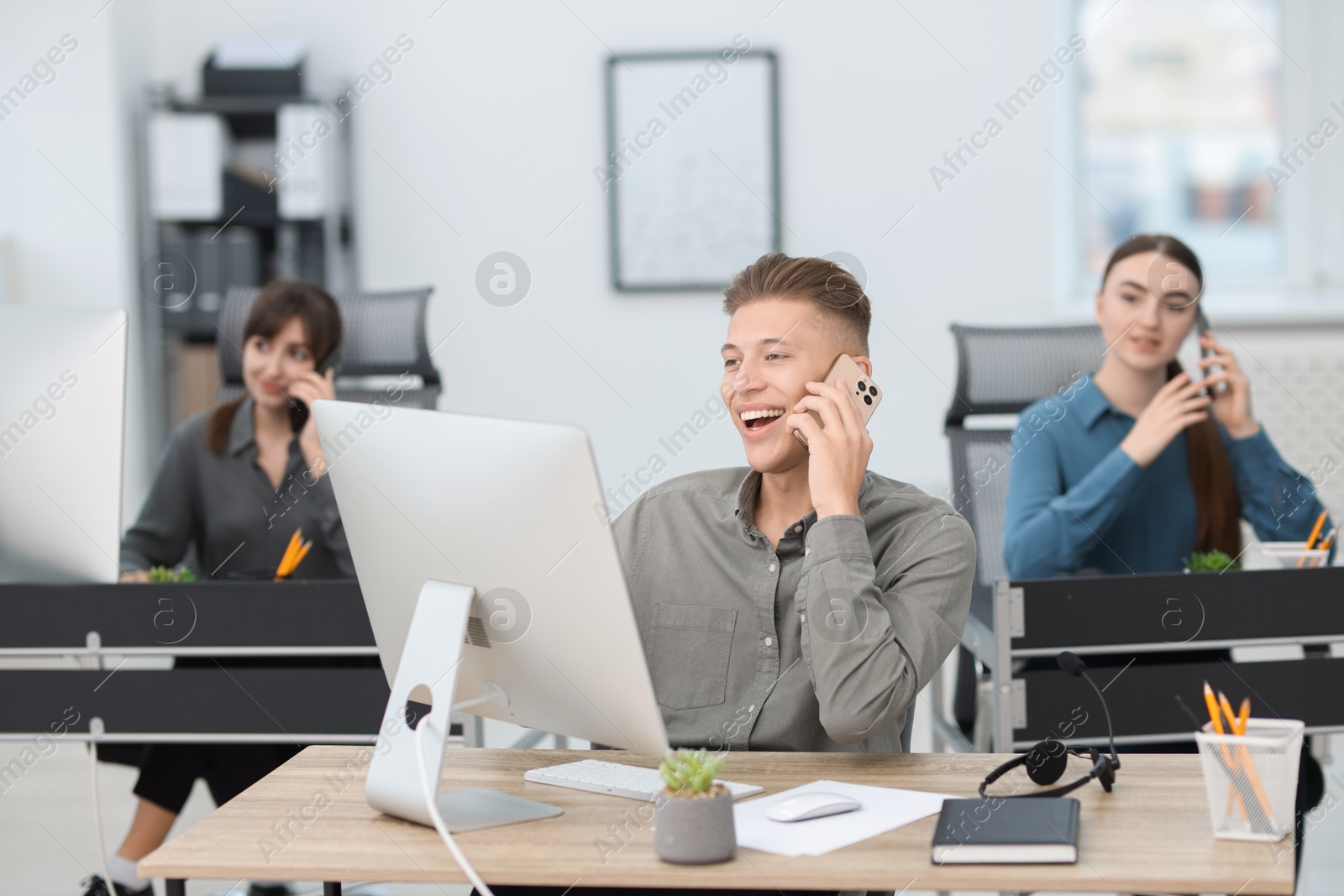 Photo of Sales department. People calling to clients in office, selective focus