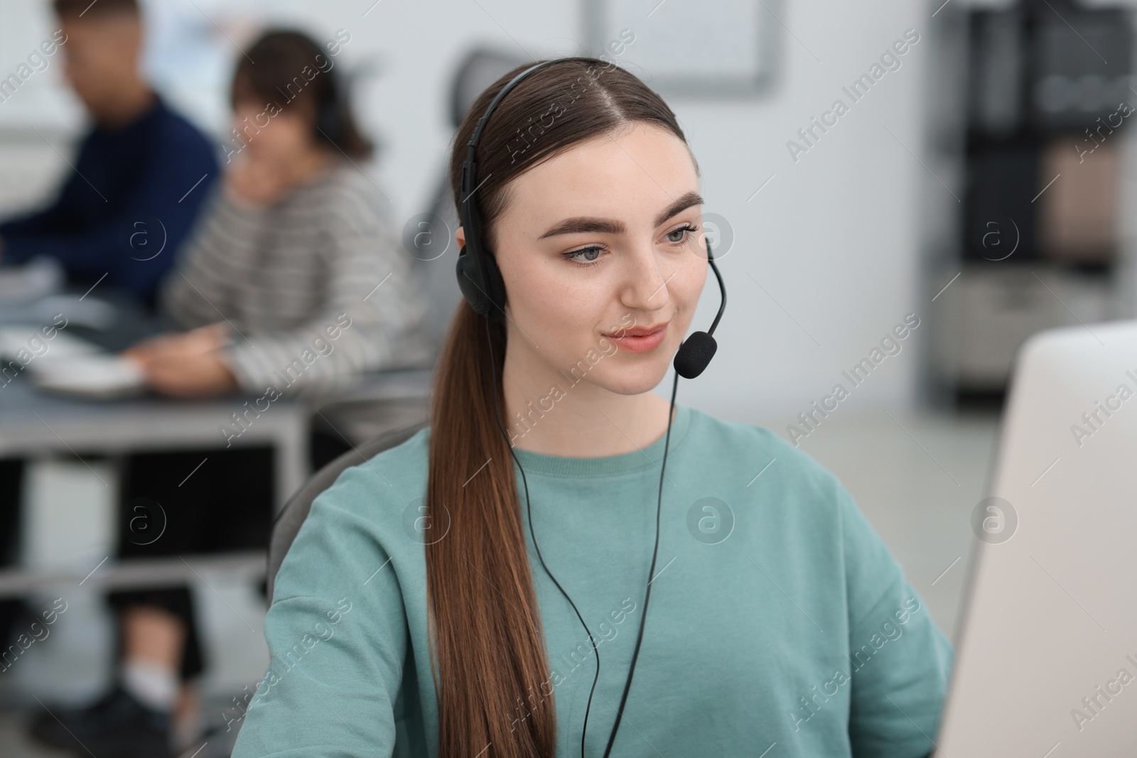 Photo of Saleswoman talking to client via headset in office