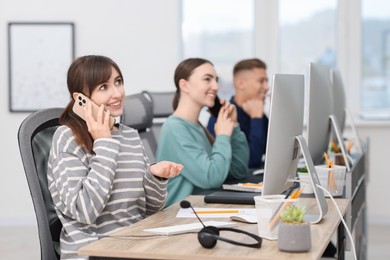 Photo of Sales department. People calling to clients in office, selective focus