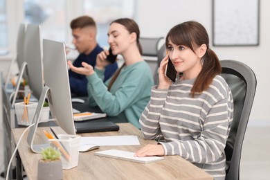 Photo of Sales department. People calling to clients in office, selective focus