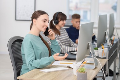 Photo of Sales department. People calling to clients in office, selective focus