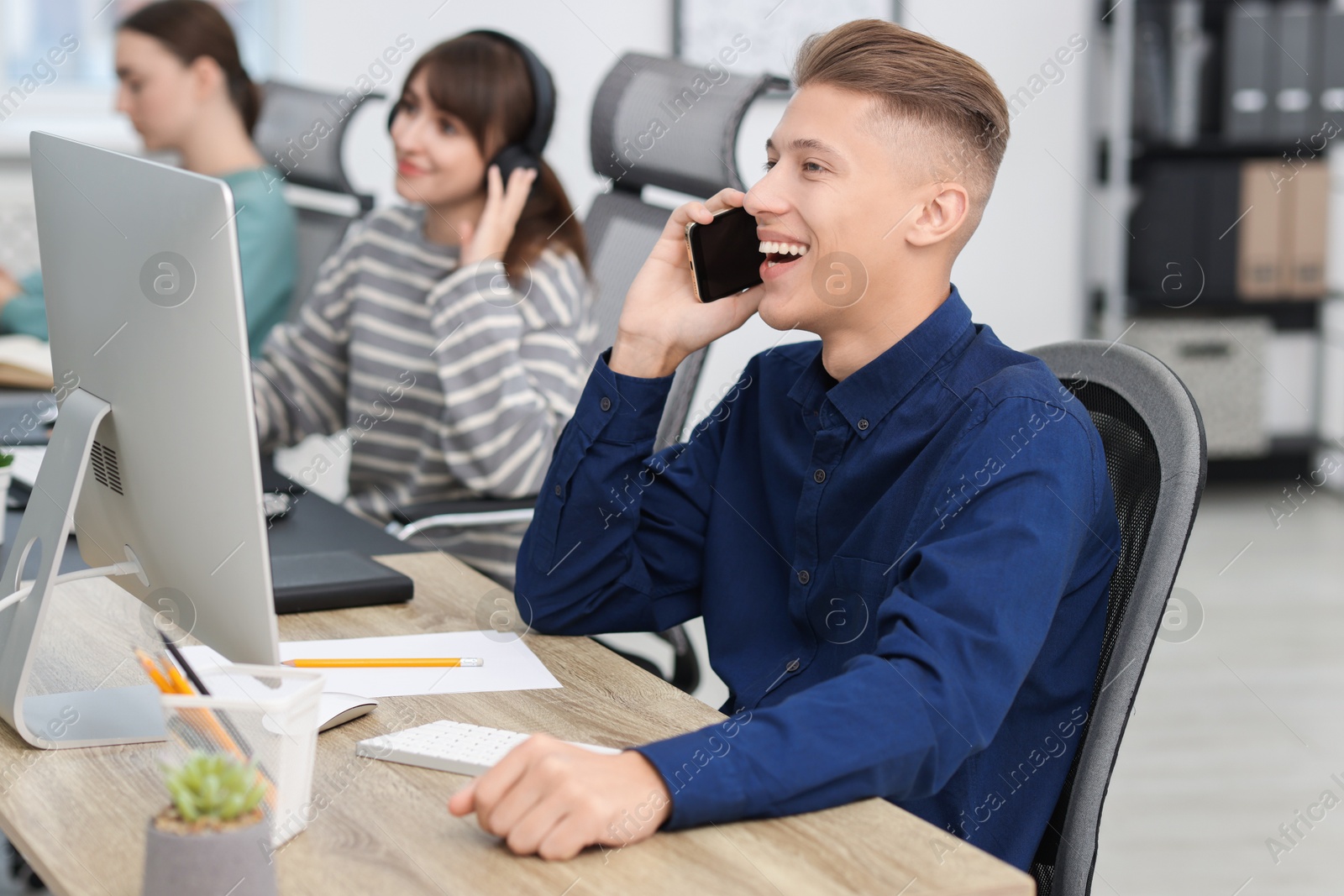 Photo of Sales department. People calling to clients in office, selective focus