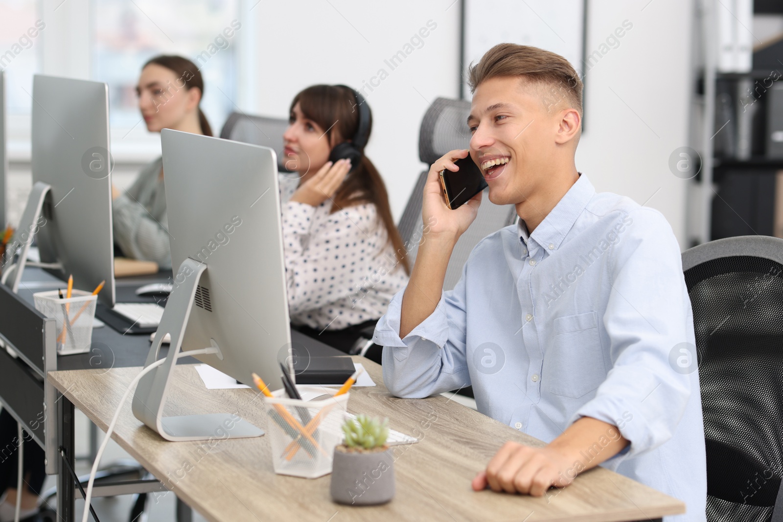 Photo of Sales department. People calling to clients in office, selective focus