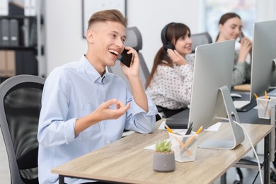 Photo of Sales department. People calling to clients in office, selective focus