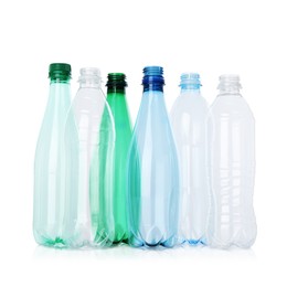 Photo of Many empty plastic bottles isolated on white