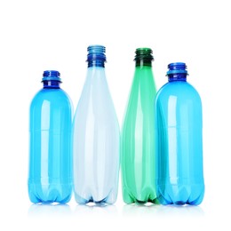 Photo of Many empty plastic bottles isolated on white