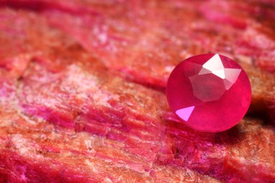 Beautiful shiny pink gemstone on natural mineral, closeup