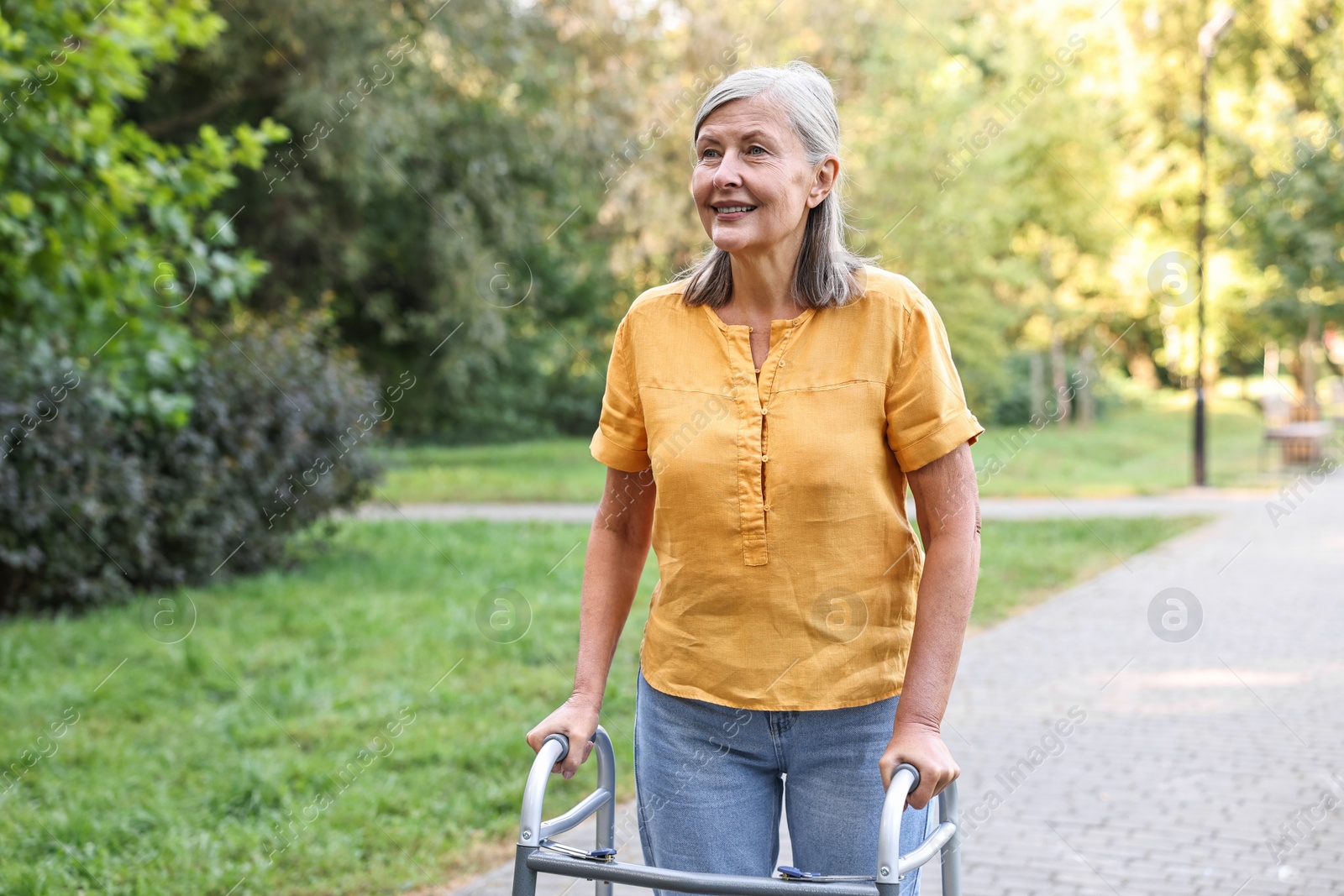 Photo of Senior woman with walking frame in park