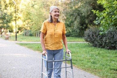 Photo of Senior woman with walking frame in park