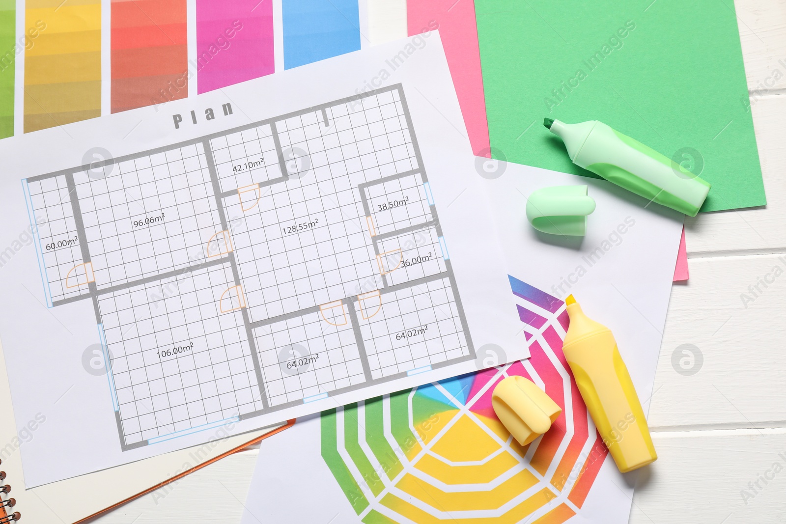 Photo of Designer's workplace with house plan, color palettes and highlighters on white wooden table, flat lay