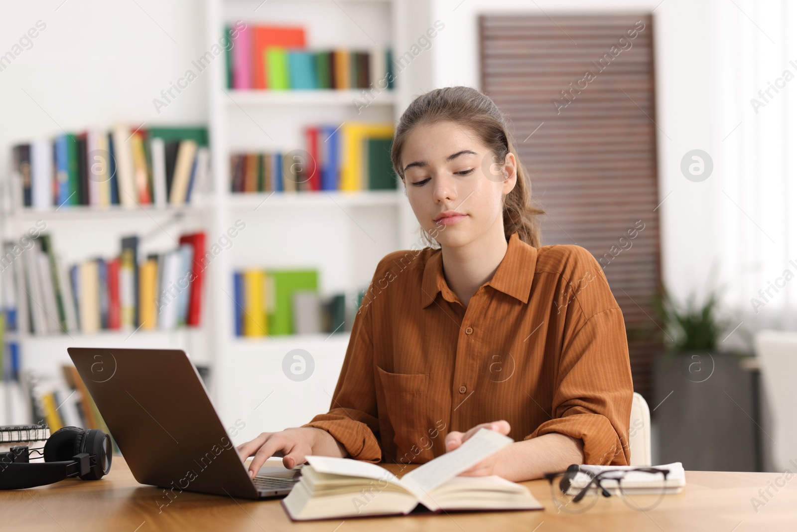 Photo of Student preparing for exam at table indoors