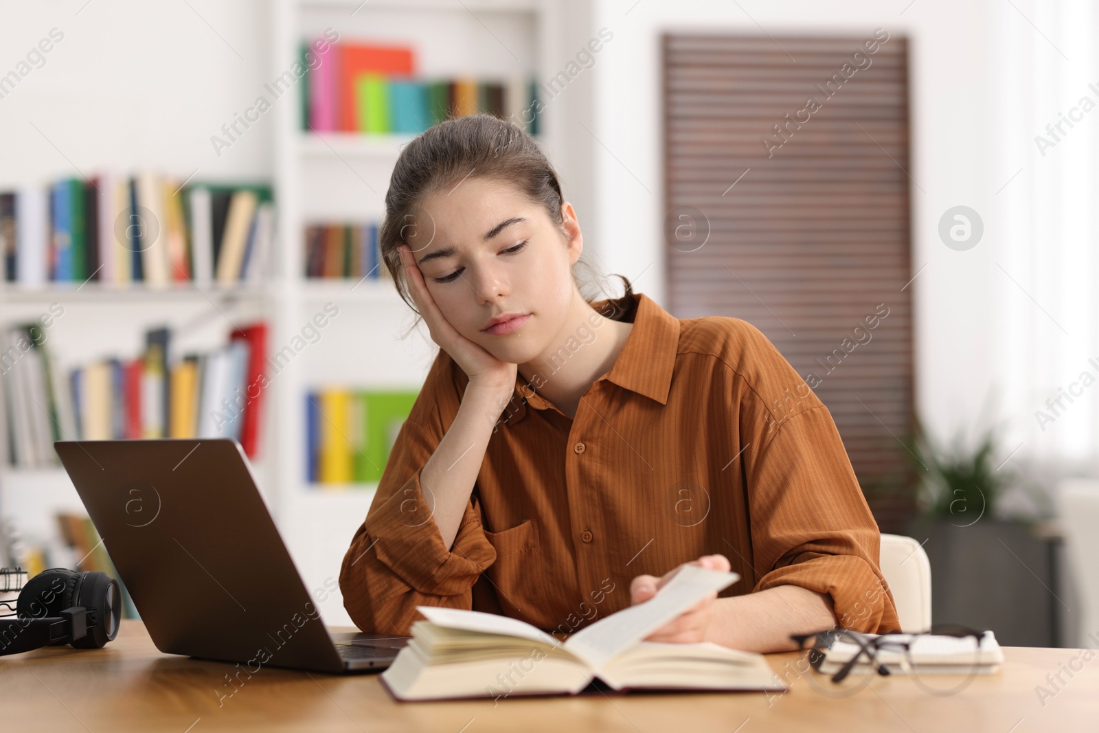 Photo of Student preparing for exam at table indoors