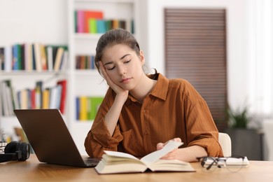 Photo of Student preparing for exam at table indoors