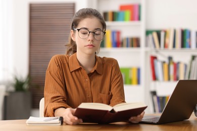 Photo of Student preparing for exam at table indoors