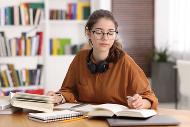 Photo of Student preparing for exam at table indoors