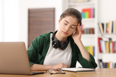 Photo of Preparing for exam. Tired student sleeping at table indoors