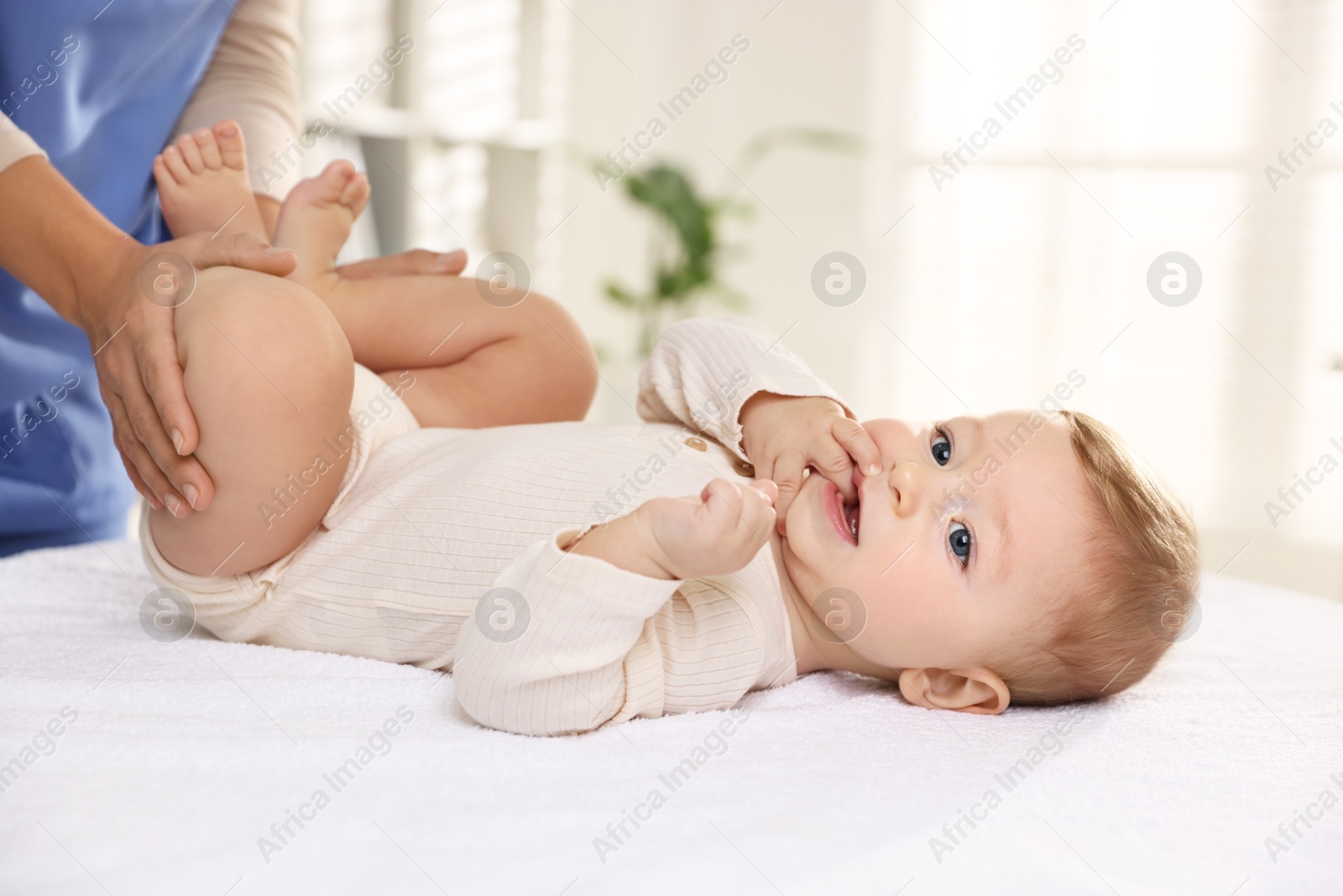 Photo of Pediatrician with little child in clinic, closeup. Checking baby's health