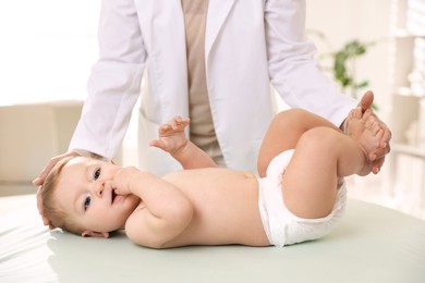 Photo of Pediatrician with little child in clinic, closeup. Checking baby's health