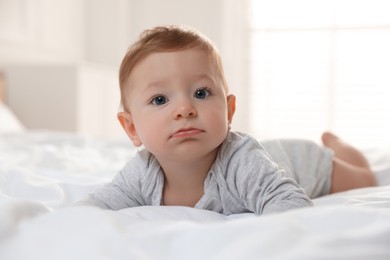 Photo of Cute little baby on bed at home