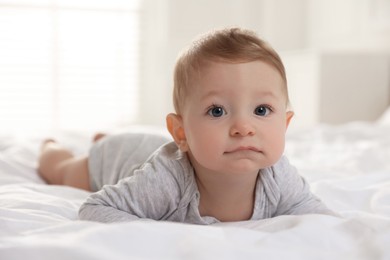 Photo of Cute little baby on bed at home