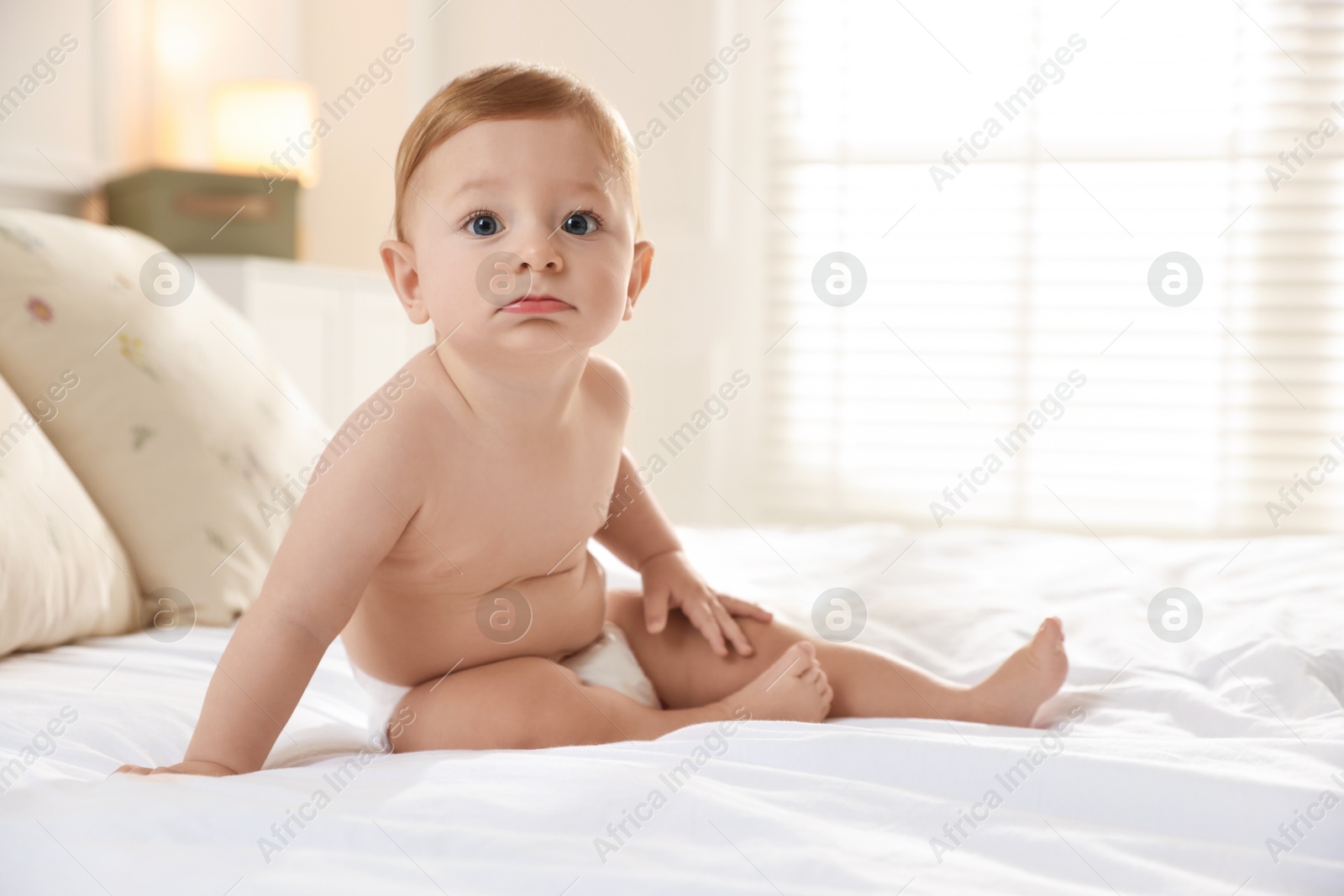 Photo of Cute little baby on bed at home